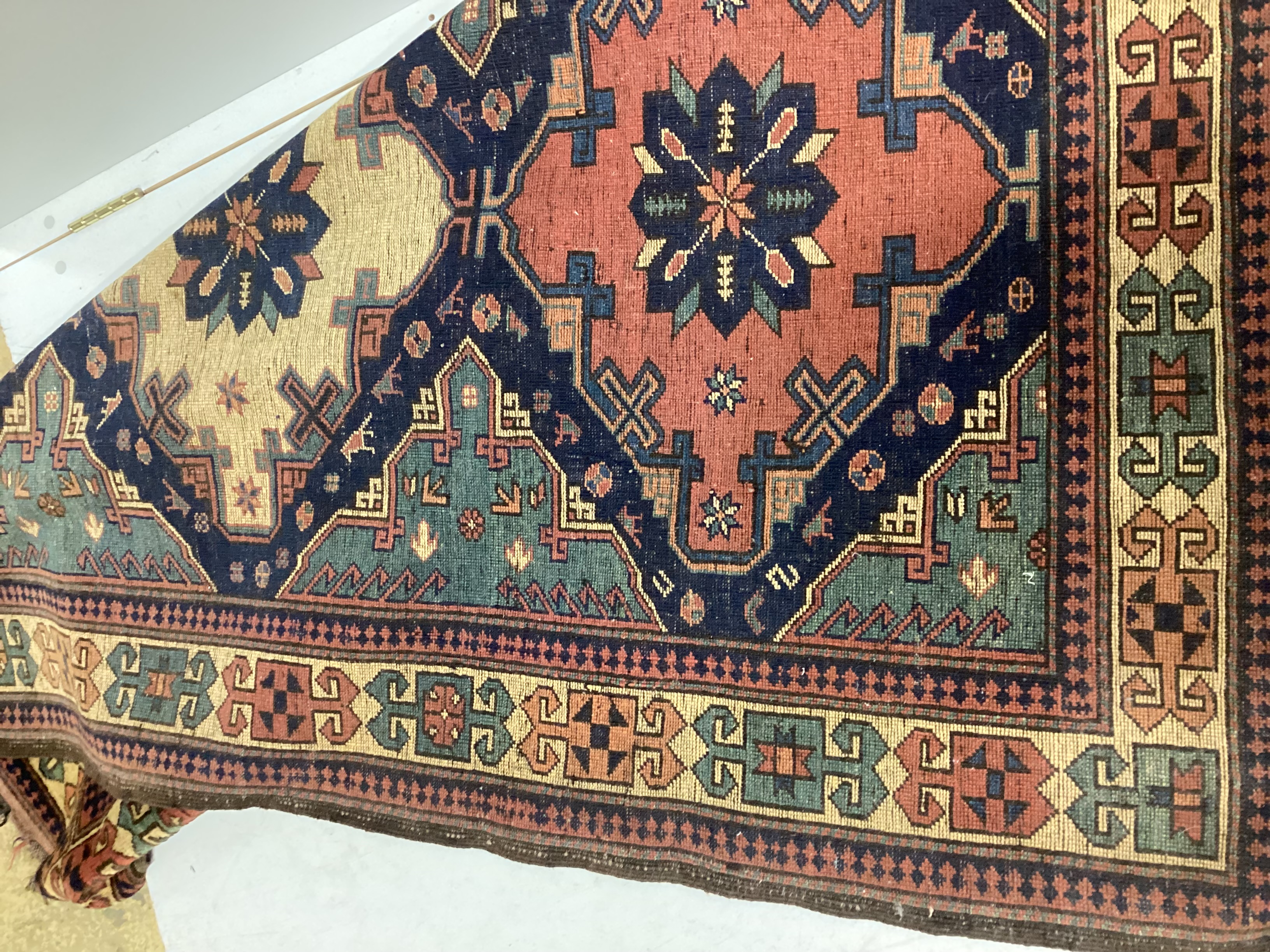 A Caucasian style blue ground triple medallion rug, 200 x 130cm